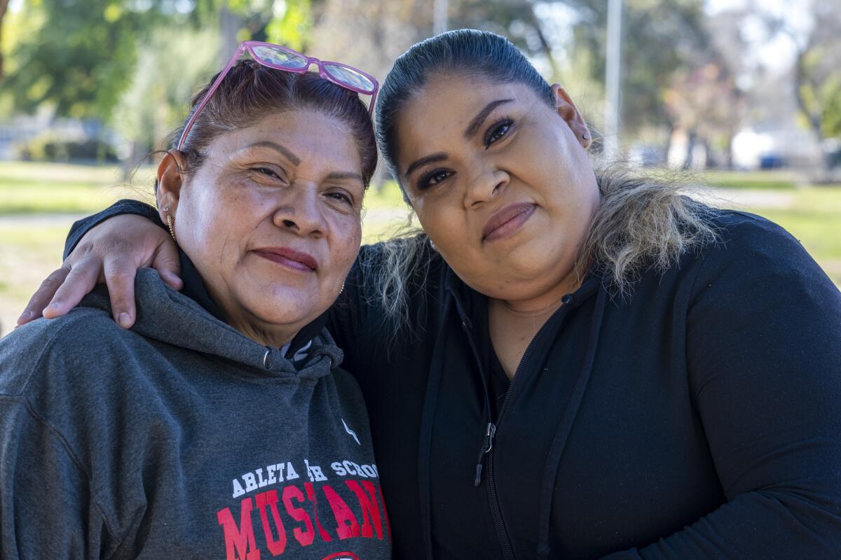 Two women on a park bench at Branford Park in Pacoima.