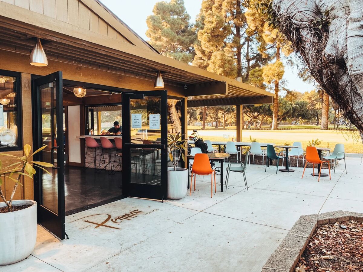 The entrance to the Penmar, with tables and chairs outside next to the building