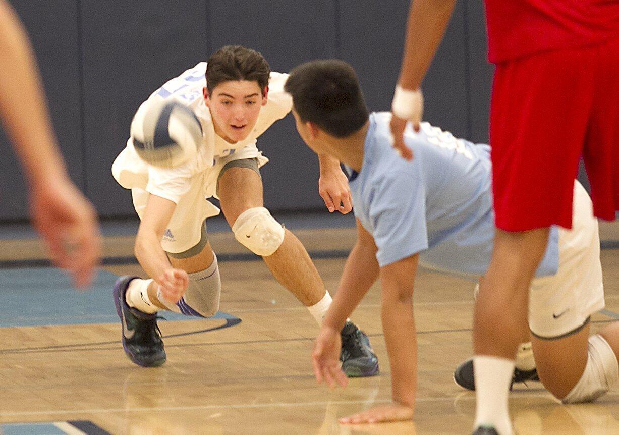 Corona del Mar High's Brandon Browning, left, keeps the ball alive against Cathedral Catholic.