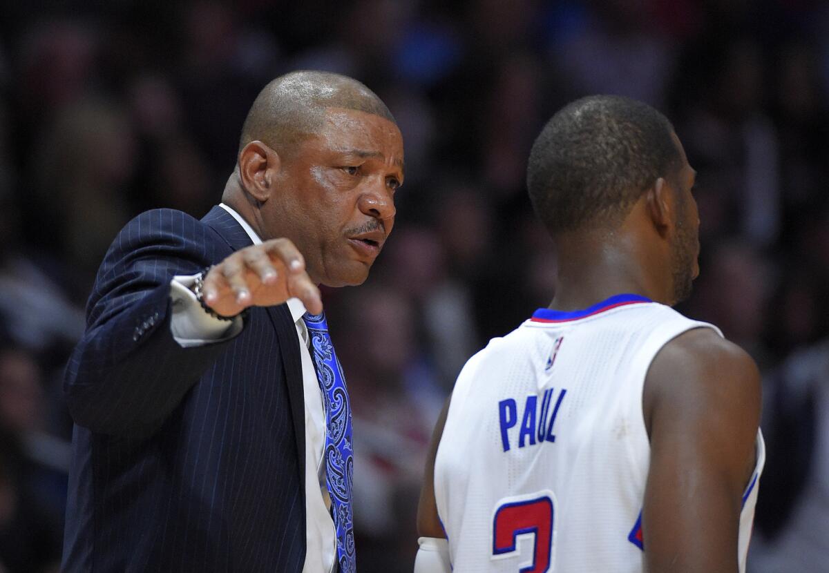 Clippers Coach Doc Rivers talks to guard Chris Paul during the second half of the team's loss to the Chicago Bulls, 105-89.