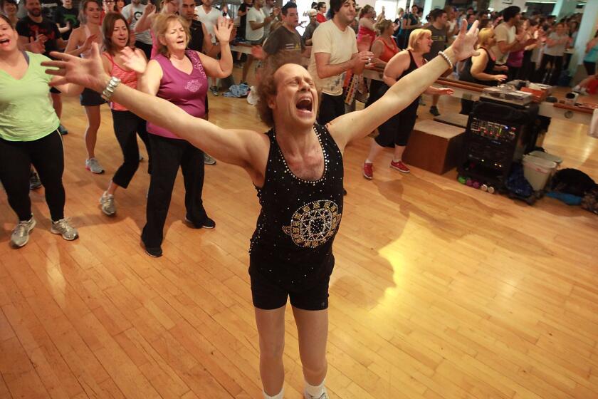 BEVERLY HILLS, CA - MARCH 9, 2013: Fitness guru Richard Simmons sings alone with one the the 60s classic tunes playing during one of his classes at Slimmons Studio March 9 2013 in Beverly Hills. (Brian van der Brug / Los Angeles Times)