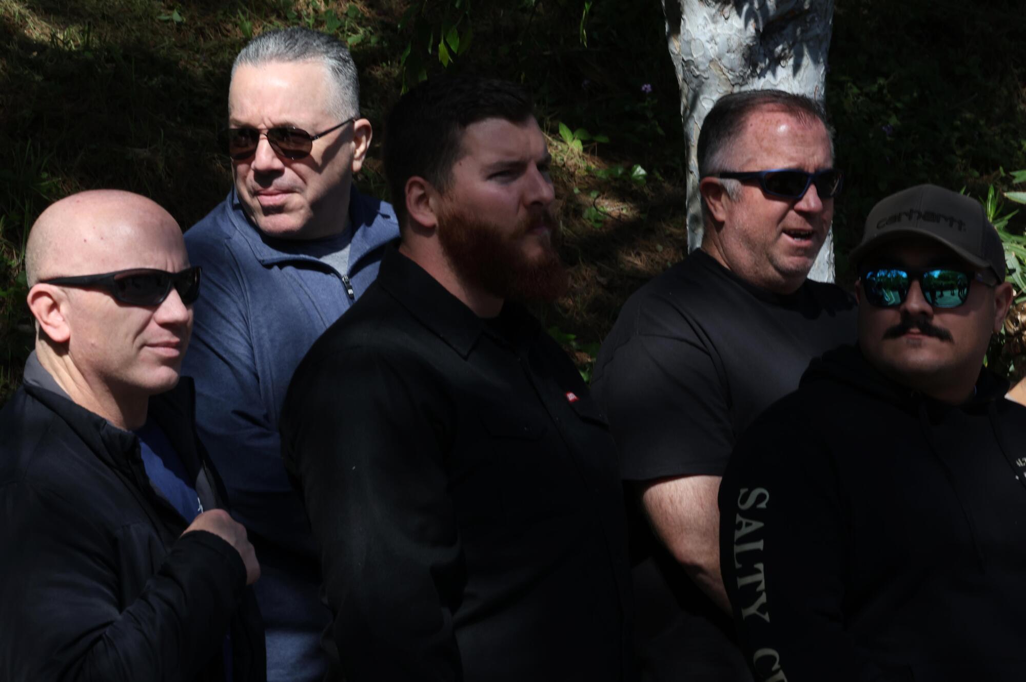 Former Sheriff Alex Villanueva, second from left, joins plainclothes sheriff's deputies at a news conference.