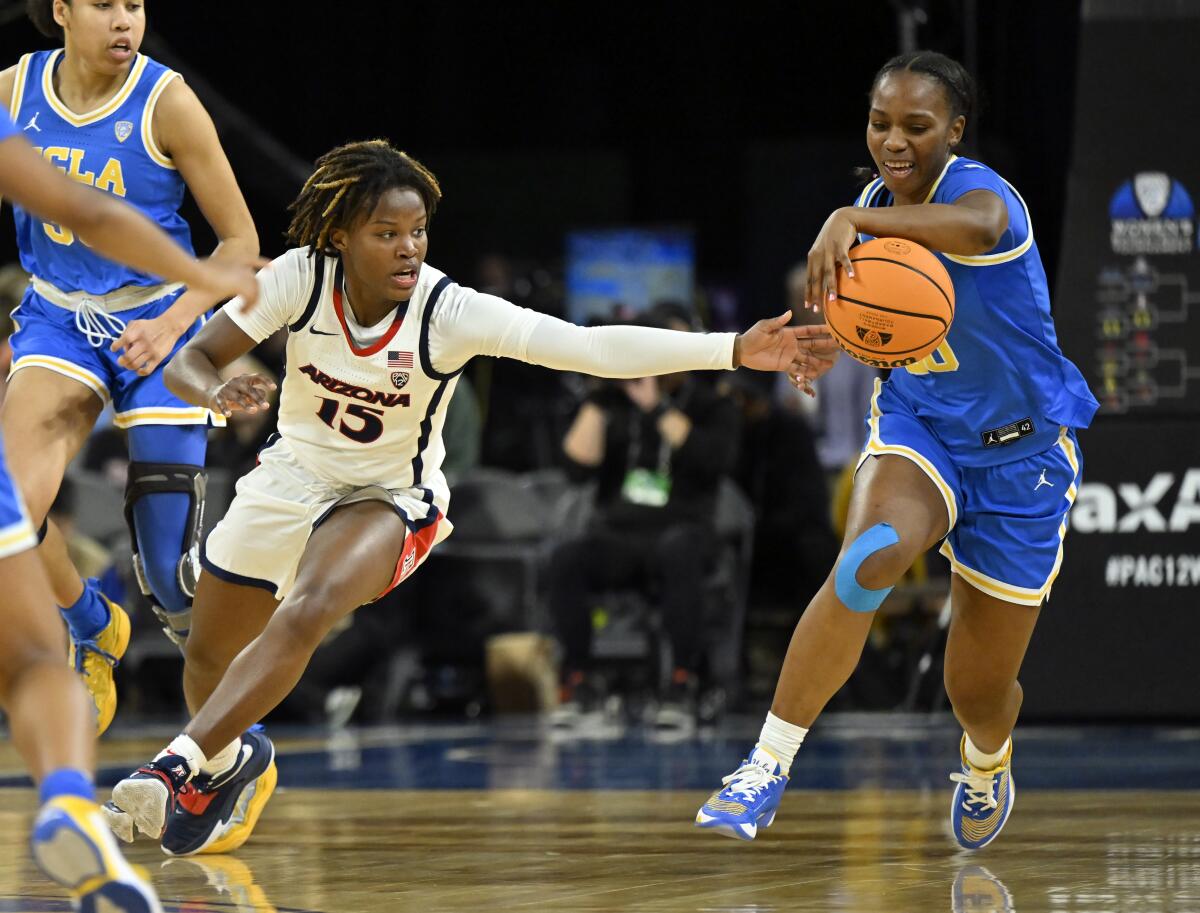 UCLA guard Charisma Osborne, right, steals the ball from Arizona guard Kailyn Gilbert during the first half Thursday.