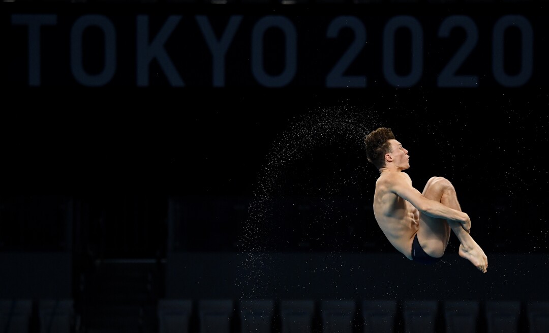 A diver dives during warm-ups.