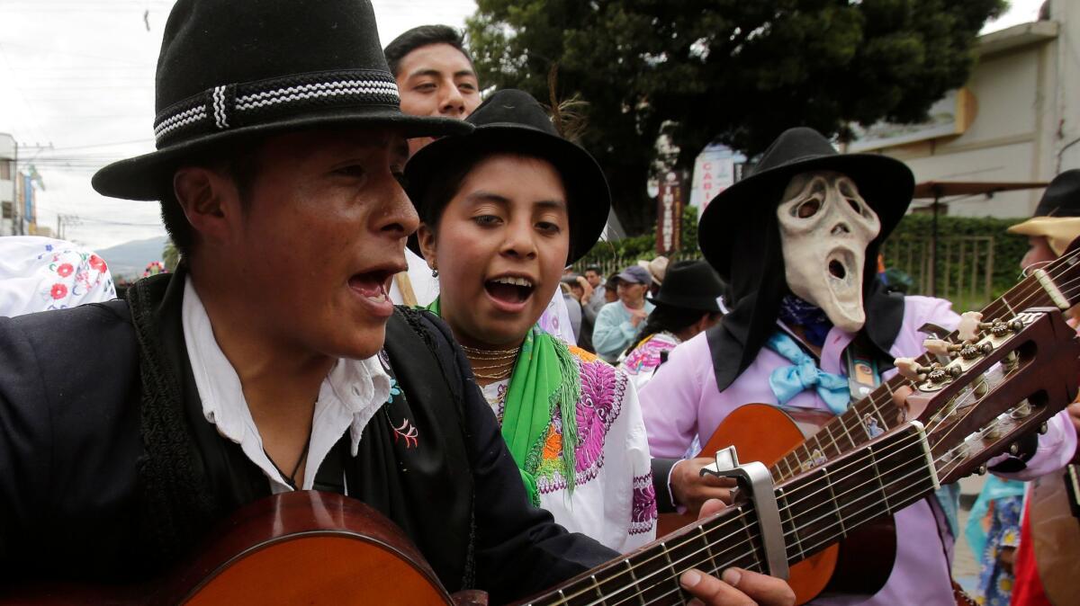 Indigenous residents sing and dance as they celebrate St. Peter's Day in the town of San Pedro de Cayambe, Ecuador, on June 29, 2017.