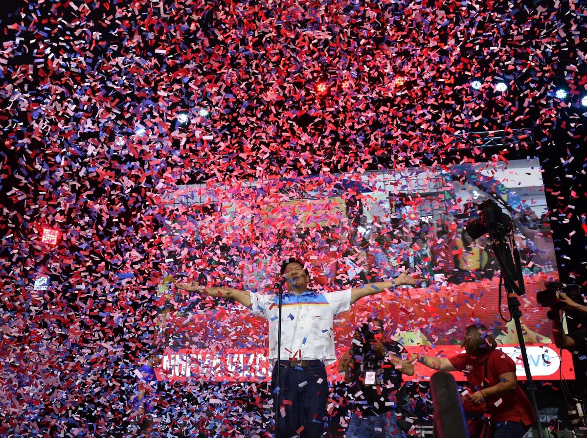 Vice-presidential candidate and son of the late dictator Ferdinand, Marcos Ferdinand Marcos Jr., reacts as confetti rains during a campaign event in Manila on May 5, 2016.