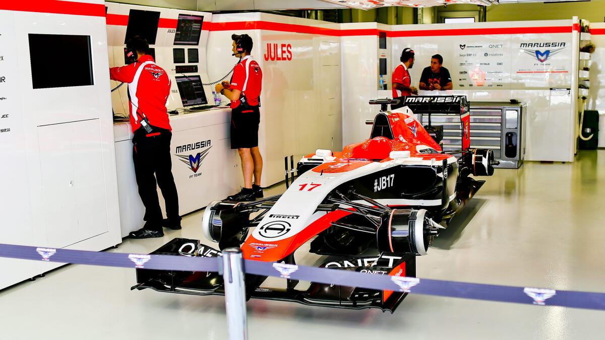 The Marussia car of injured driver Jules Bianchi sits in the garage during a Formula One practice session Friday at the Sochi Autodrom in Sochi, Russia.
