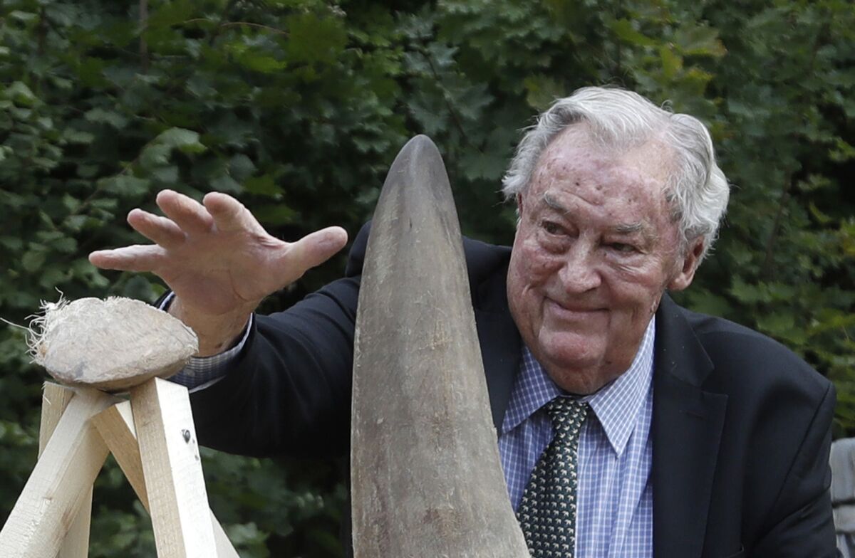 FILE - Richard Leakey, Kenyan wildlife conservationist, places a rhino horn to be burned at the zoo in Dvur Kralove, Czech Republic, Tuesday, Sept. 19, 2017. Paleoanthropologist Richard Leakey, known for his fossil-finding and conservation work in his native Kenya, has died at 77. His death was announced Sunday, Jan. 2, 2022 by Kenyan President Uhuru Kenyatta. The cause of death was not announced. (AP Photo/Petr David Josek, File)