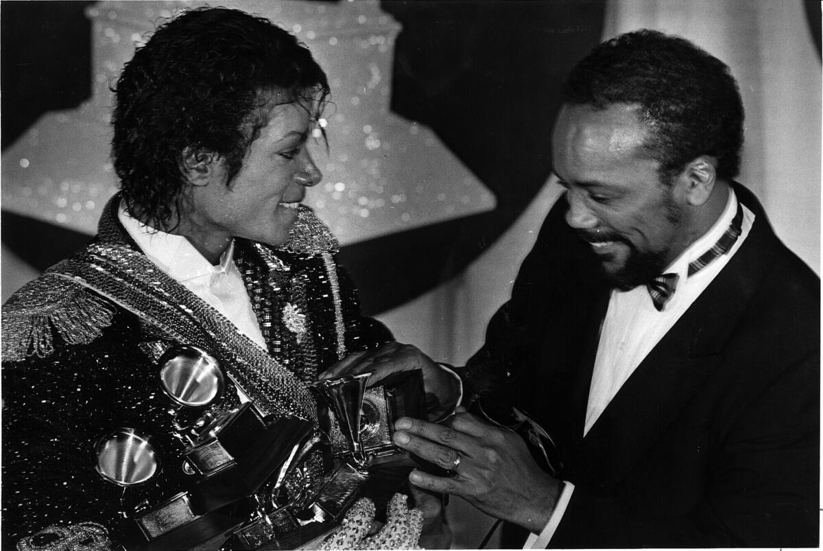 Michael Jackson, left, with producer Quincy Jones with Grammys for Jackson's album 'Thriller' in 1984.