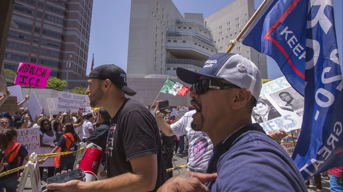 Trump supporters argue with protesters decrying the administration's immigration and refugee policies on June 30 in Los Angeles.