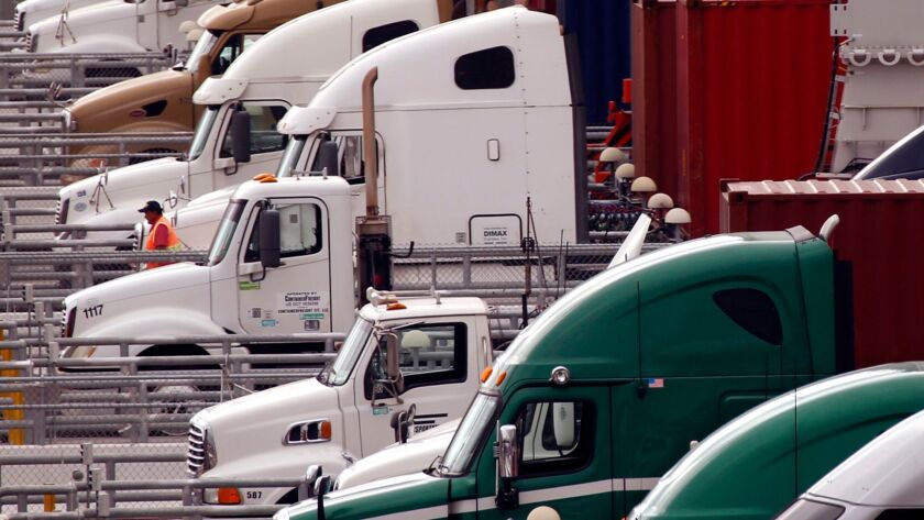 Trucks prepare to leave their shipping containers at the Port of Los Angeles on Nov. 2, 2017.