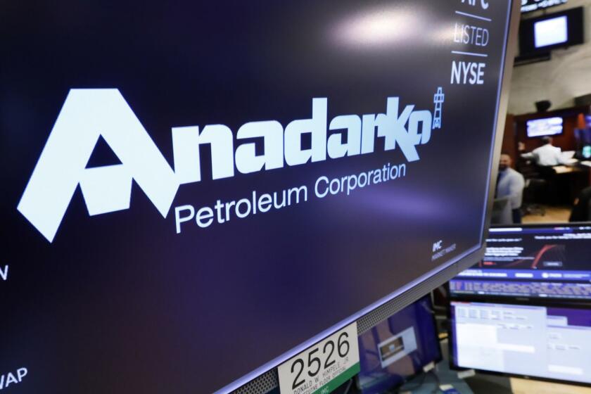 FILE - In this April 12, 2019, file photo the logo for Anadarko Petroleum Corp. appears above a trading post on the floor of the New York Stock Exchange. Warren Buffets Berkshire Hathaway is financing a bid by Occidental Petroleum for Anadarko, potentially upending Chevrons $33 billion offer for the energy company. Anadarko and Chevron signed a merger agreement earlier this month, but Anadarko Petroleum said Monday, April 29, that it is now considering an offer from Occidental worth about $57 billion in cash and stock. (AP Photo/Richard Drew, File)