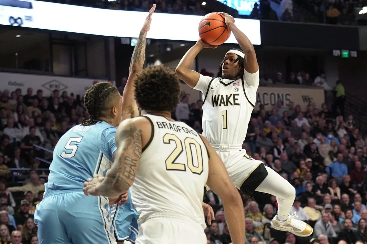 Wake Forest's Tyree Appleby (1) shoots over North Carolina forward Armando Bacot (5) during the first half of an NCAA college basketball game in Winston-Salem, N.C., Tuesday, Feb. 7, 2023. (AP Photo/Chuck Burton)