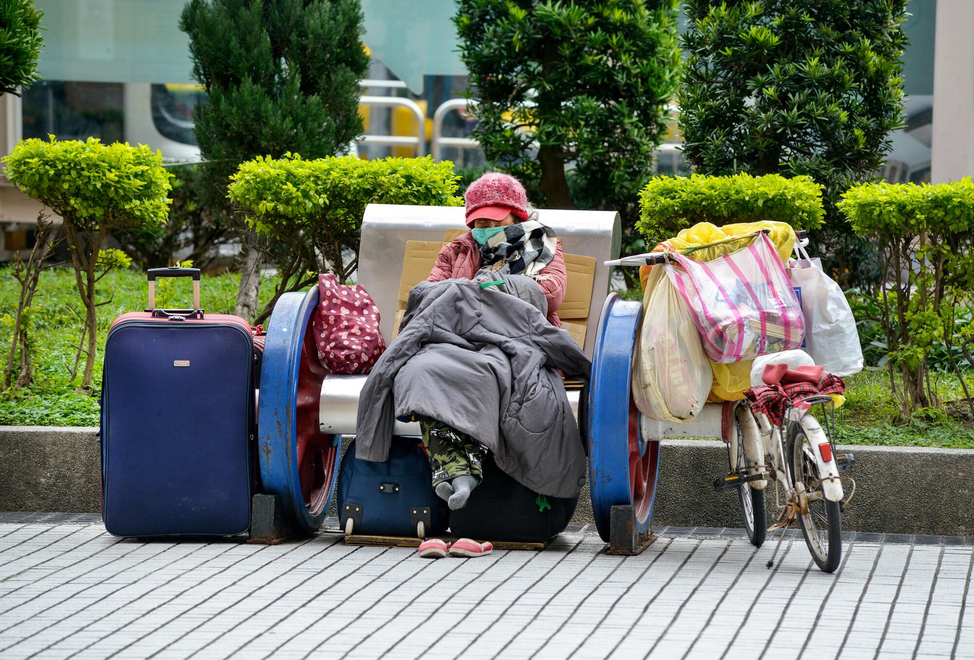 A homeless woman with her belongings at the main rail station in Taipei, Taiwan.