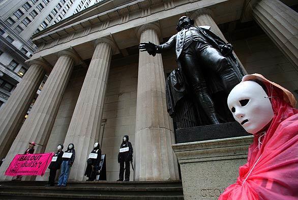 Members of the antiwar group Code Pink protest on Wall Street, staging a demonstration in front of a statue of George Washington at Federal Hall.