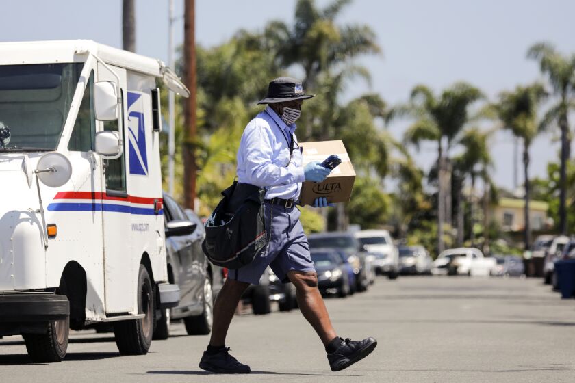 SAN CLEMENTE, CA - MAY 15: Mailman James Daniels, 59, on his mail delivery route on Friday, May 15, 2020 in San Clemente, CA. (Irfan Khan / Los Angeles Times)