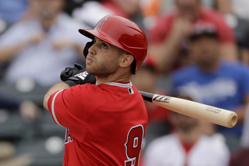 Angels second baseman Tommy La Stella bats during a spring training game against the Rangers.
