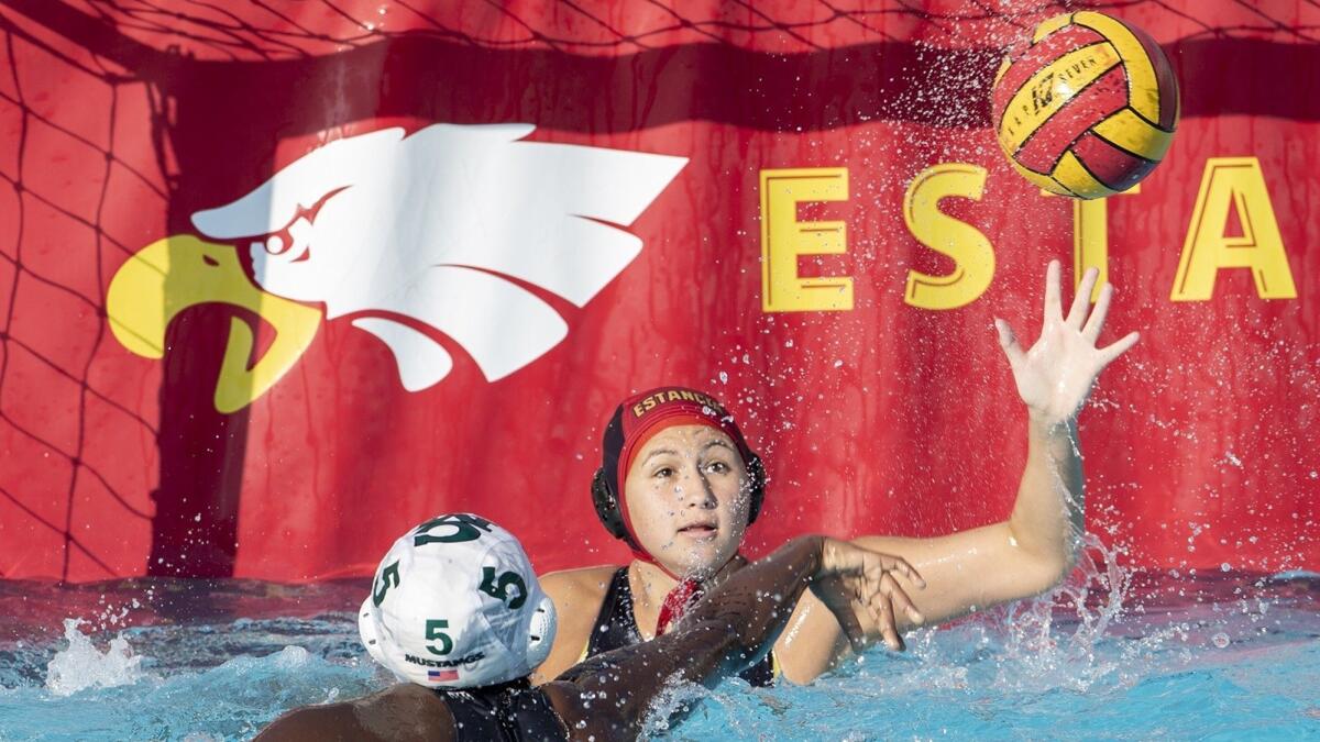 Costa Mesa High's Sey Currie takes a shot against Estancia goalkeeper Giannina Bauer in an Orange Coast League match on Wednesday.