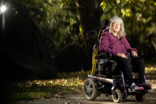 ALBANY, CA - NOVEMBER 11, 2021 - Beth Smith pauses for a photo at a park near her home in Albany, California on November 11, 2021. Smith is part of a lawsuit against a health insurance company alleging discrimination against disabled people. (Josh Edelson/for the Times)