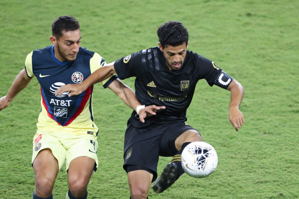 Club América's Sebastian Caceres, left, and LAFC's Carlos Vela battle for control of the ball.