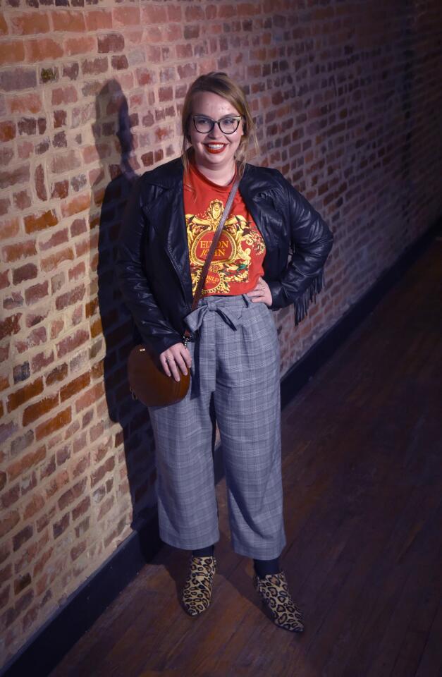 Who: Maddie Cooper, 25, Wilmington, Del., resident, University of Delaware graduate student/show standup comic Spotted at: Prim and Proper all-woman comedy showcase at Charm City Comedy Project at Zissimos What she wore: Elton John tour T-shirt from Goodwill; gray plaid pants and Mossimo black vegan leather fringe jacket from Target; Sam Edelman leopard print booties from DSW; Brahmin cognac round crossbody bag that was a gift; and cats-eye glasses from Warby Parker. Her style: "I like to mix patterns and textures. I feel like I like a strong shoulder for 2019. I like my clothes to be able to transition from day to sleeping."