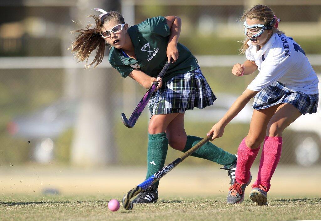 Edison High's Sarah Shklanko, left, passes the ball defended by Newport Harbor's Allana Rockwell, right, during the second half in a Sunset League game at Davidson Field on Tuesday.