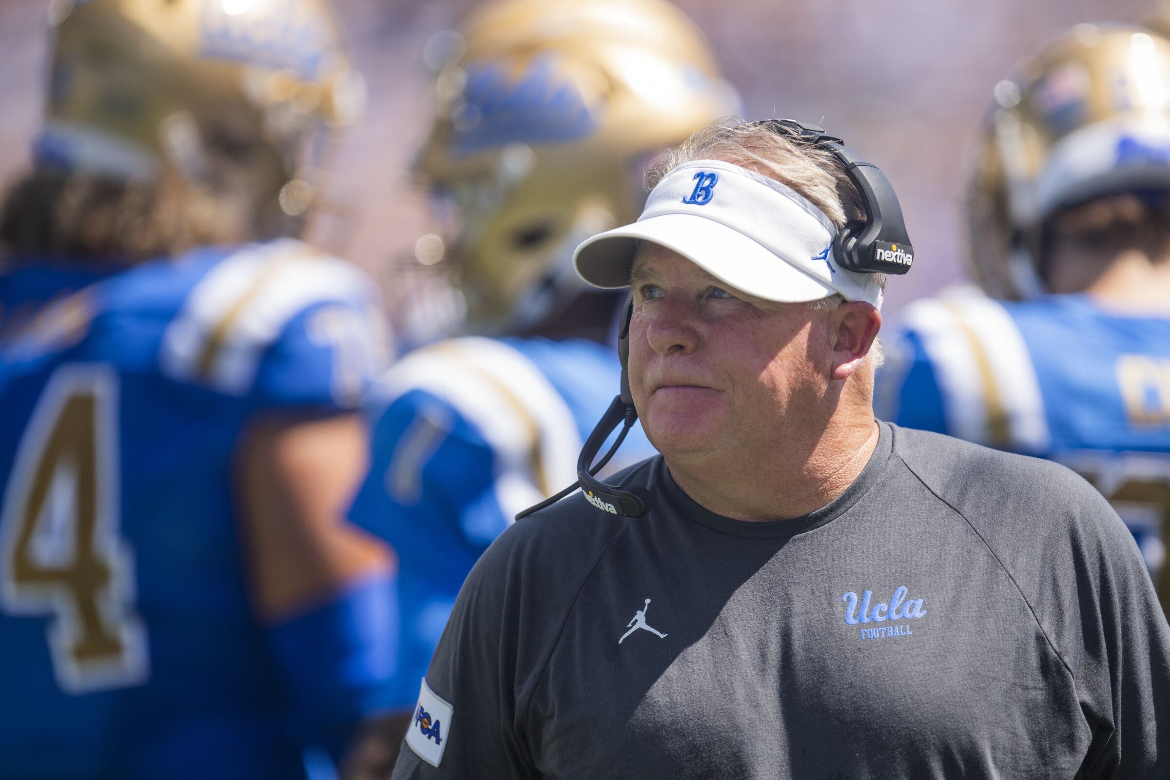 UCLA coach Chip Kelly walks on the sideline during a win over Hawaii in August.