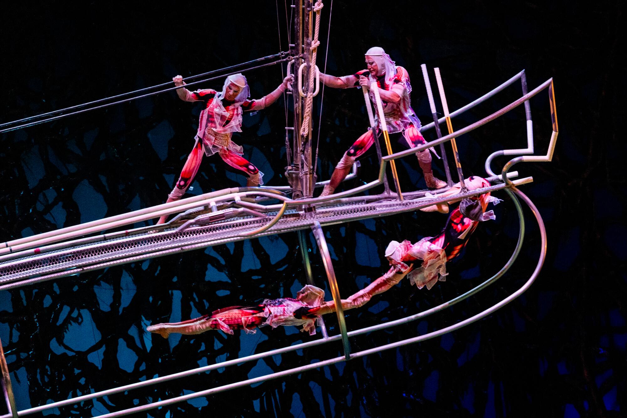 Acrobats perform on an aerial seesaw during Cirque du Soleil's "O."