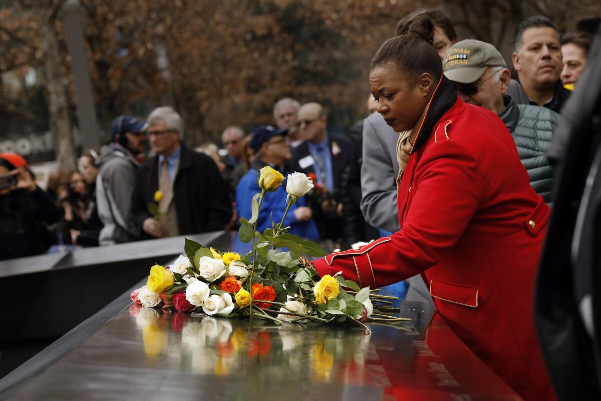 Lolita Jackson of New York survived both the 1993 and the 2001 attacks on the World Trade Center. She places a rose commemorating the 25th anniversary of the 1993 World Trade Center bombing during a ceremony at the site Monday.