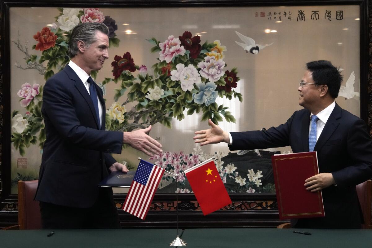 California Gov. Gavin Newsom shaking hands with Chinese official