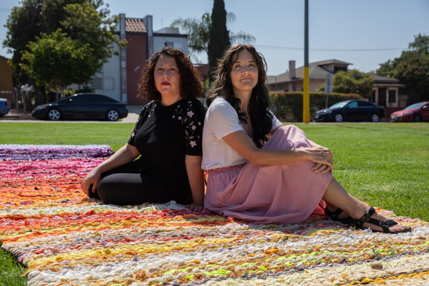 Artists Yvette Roman (left) and Sheena Rae Dowling (right) pose for a portrait at San Ysidro Community Park.