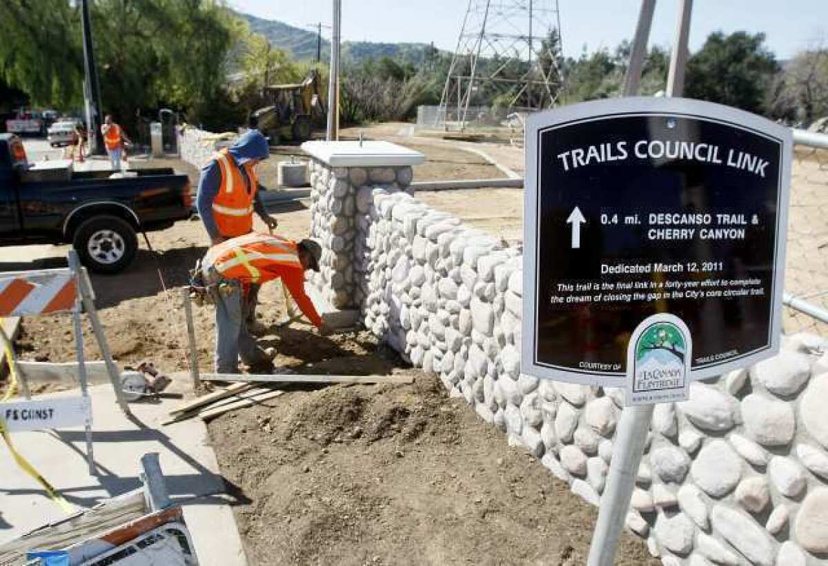FS Construction workers Salvador Hernandez, standing, and Oscar Rivera prepare the sidewalk and driveway area for the pouring of concrete at The Passive Park Trail Concil Link at Indiana Ave. and Foothill Blvd. in La Cañada Flintridge. The area is on So. Cal Edison property.