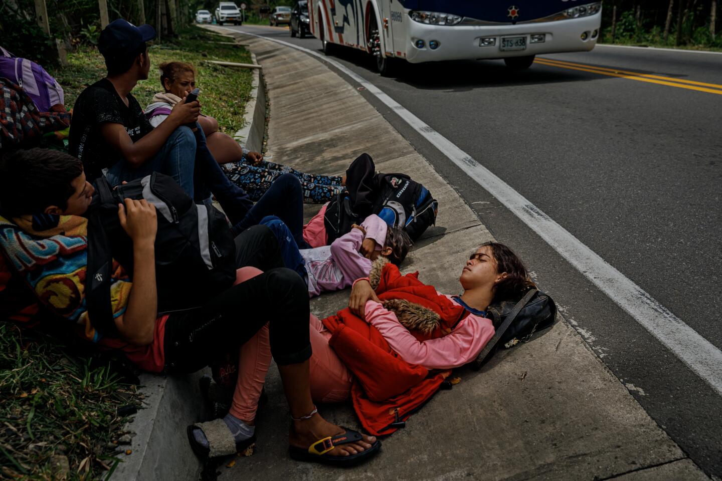 Delimar Fonseca, 18, rests with family and friends on the side of Route 55 near Jimenez, Colombia.