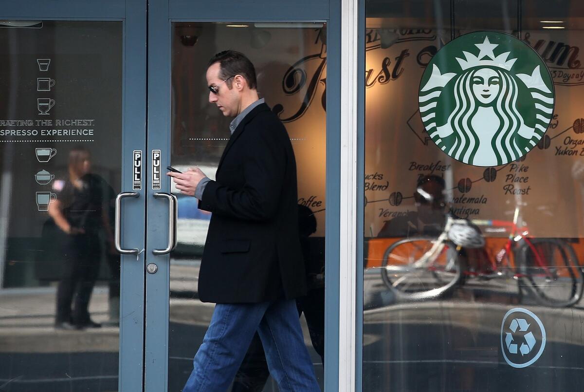 A pedestrian walks by a Starbucks Coffee shop on January 22, 2015 in San Francisco. The Burbank Planning Board has denied a request for the Starbucks at Olive and Verdugo avenues to serve beer and wine.