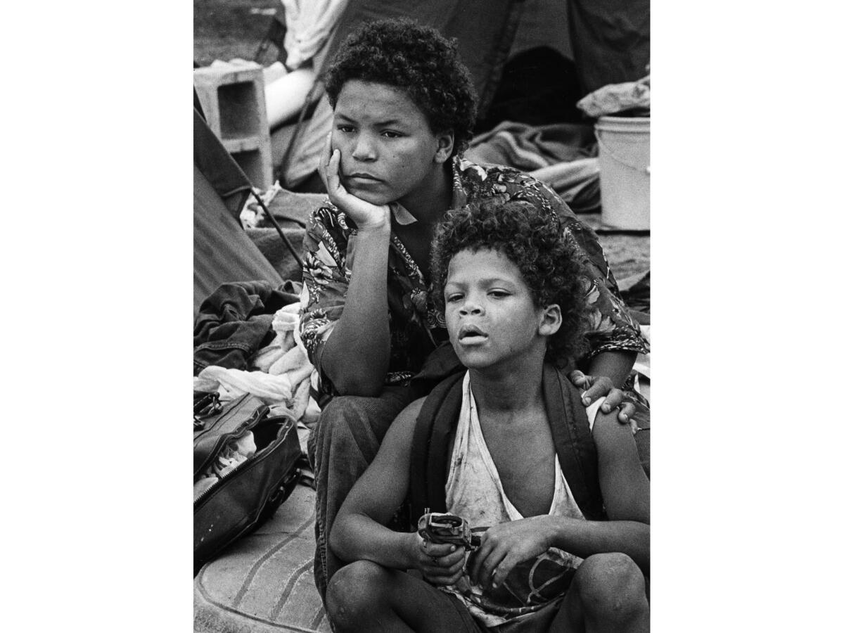 Aug. 13, 1987: Segura Williams, 13, left, with his brother Lamartina, 7, outside of their tent.