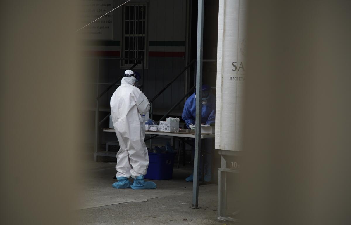 Fuera del hospital hay un área de pruebas de coronavirus. El personal toma precauciones trabajando con posibles muestras de coronavirus.