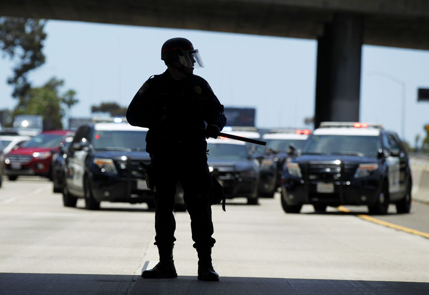 CHP officers in riot gear tried to stop a group of protesters on the I-5 in the East Village of San Diego on May 31, 2020.