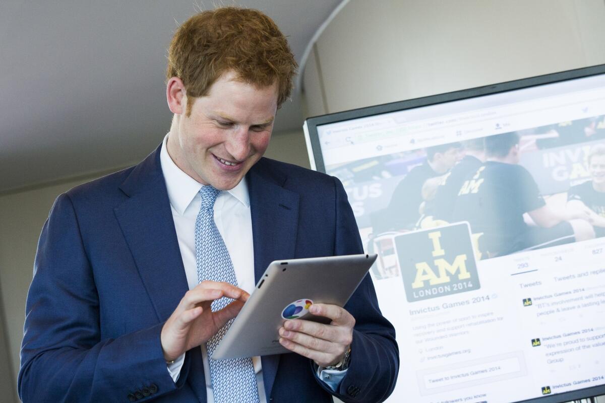 Prince Harry attends a news conference where he sends his first-ever tweet to mark tickets going on sale for the Invictus Games in London.
