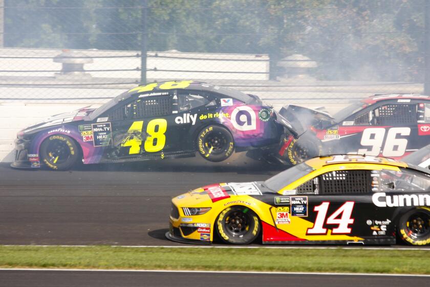 NASCAR driver Jimmie Johnson (48) is hit by Parker Kligerman (96) in the second turn during the NASCAR Brickyard 400 auto race at the Indianapolis Motor Speedway, Sunday, Sept. 8, 2019, in Indianapolis. (AP Photo/Mike Fair)