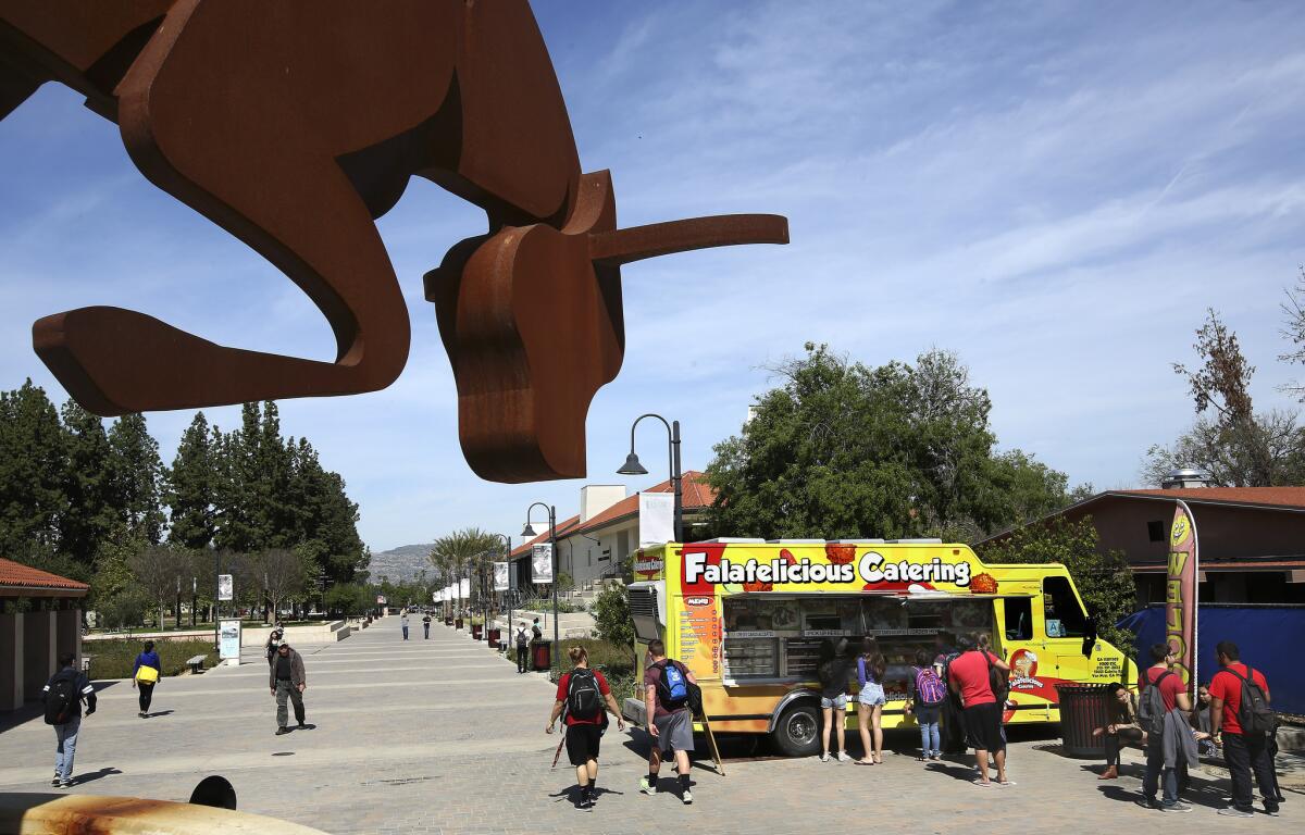 Students line up at a food truck at Pierce College in Woodland Hills. The campus has no cafeteria.