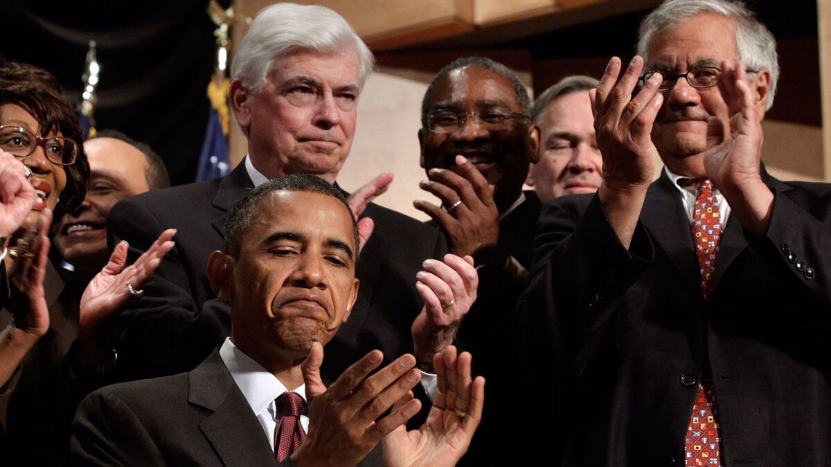President Barack Obama applauds after signing the the Dodd-Frank financial reform bill into law in 2010, joined by Senate Banking Committee Chairman Christopher Dodd (D-Conn.), center, and House Financial Services Committee Chairman Barney Frank (D-Mass.), right. (Chip Somodevilla / Pool / EPA)