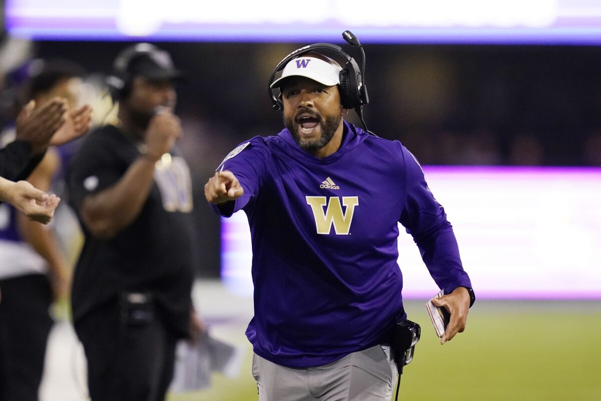 FILE - Washington head coach Jimmy Lake yells toward the field in the first half of an NCAA college football game against California, Saturday, Sept. 25, 2021, in Seattle. On Sunday, Nov. 14, 2021, Washington fired Lake less than two years after he was chosen to succeed Chris Petersen. (AP Photo/Elaine Thompson, File)