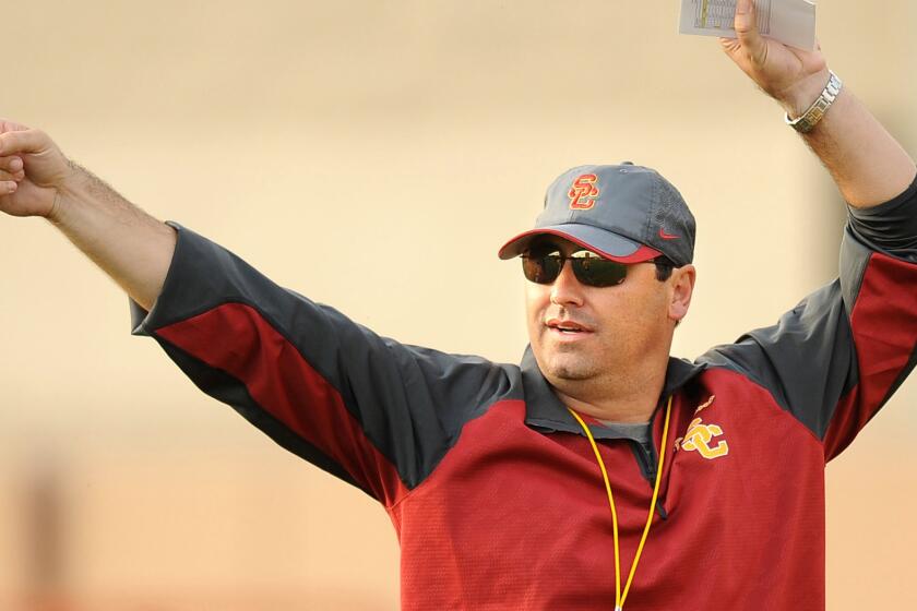 USC head coach Steve Sarkisian instructs his players during practice in March 2014 at the Trojan campus.