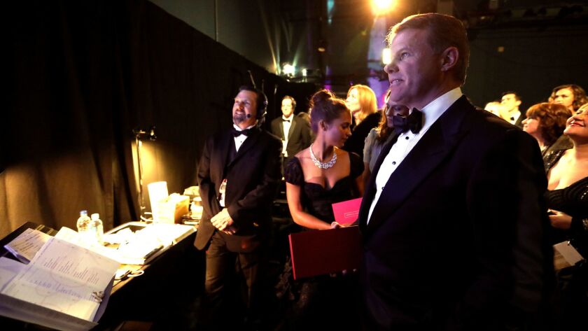 PricewaterhouseCoopers accountant Brian Cullinan, right, backstage at the Academy Awards on Sunday with actress and presenter Alicia Vikander, holding red winner's envelope, and stage manager John Esposito, left.