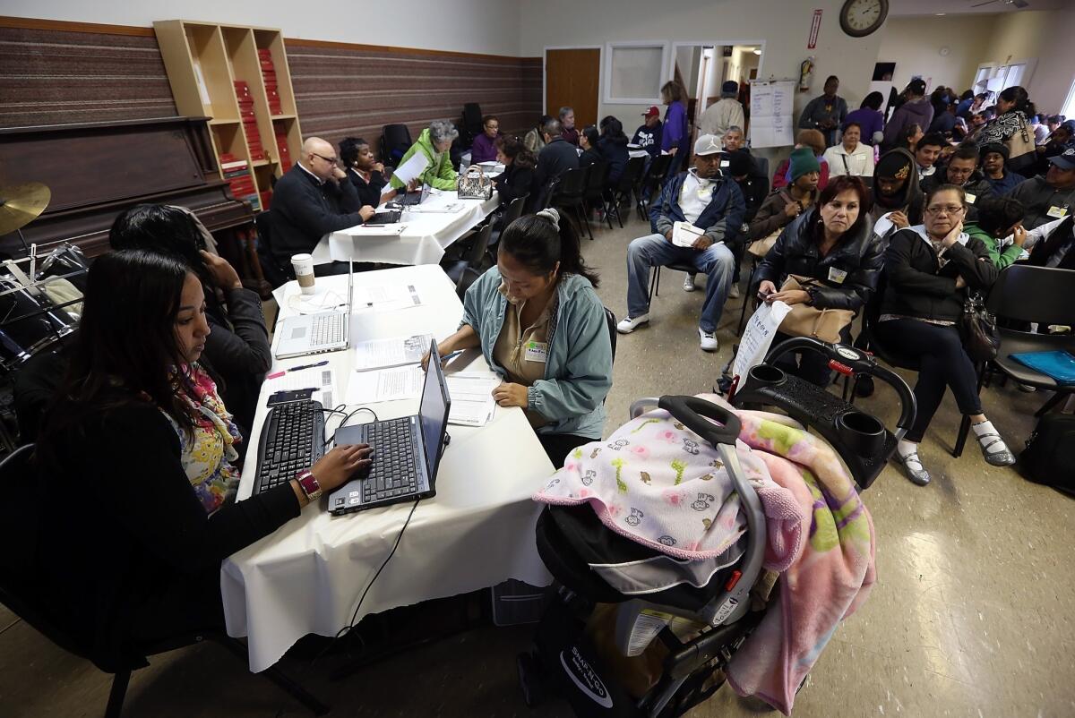 Workers help applicants register for Medi-Cal in Richmond, Calif.