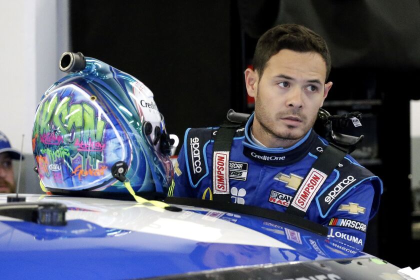 FILE - In this Feb. 14, 2020, file photo, Kyle Larson gets ready to climb into his car to practice for the NASCAR Daytona 500 auto race at Daytona International Speedway in Daytona Beach, Fla. Kyle Larson used a racial slur on a live stream Sunday. April 12, 2020, during a virtual race — the second driver in a week to draw scrutiny while using the online racing platform to fill time during the coronavirus pandemic.(AP Photo/Terry Renna, File)