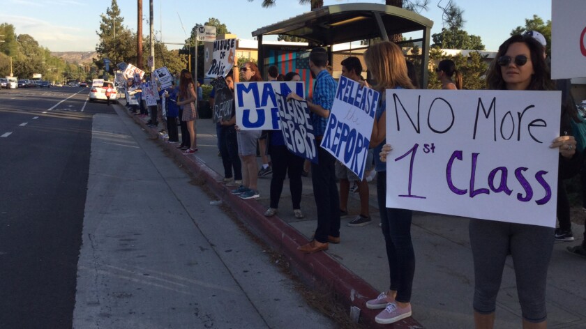 Protesters outside El Camino Real Charter High School last week criticized first-class air travel taken by executive director David Fehte and called for the release of an internal probe.