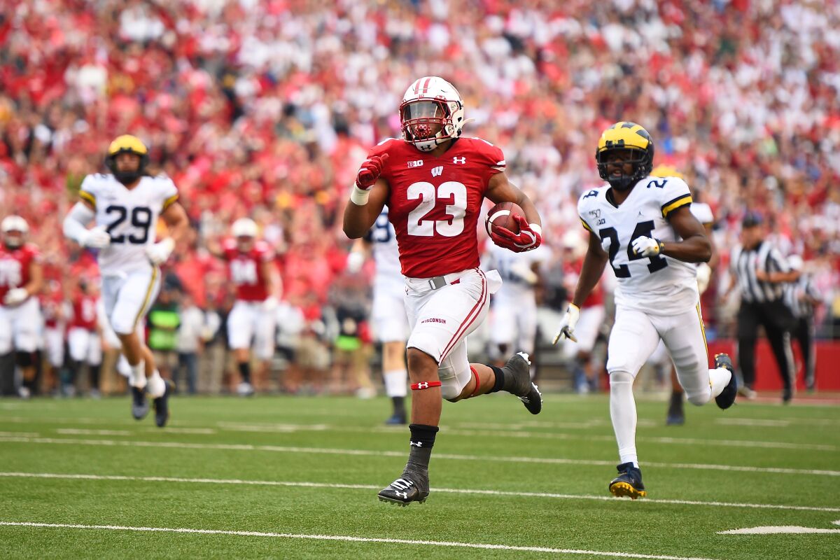 Badgers running back Jonathan Taylor (23) beats the Wolverines' defense for a touchdown during the first half at Camp Randall Stadium on Sept. 21, 2019.