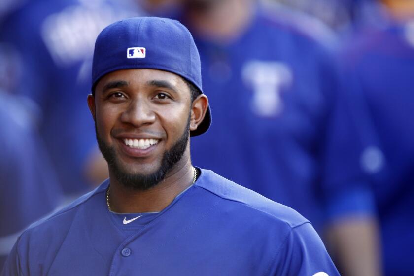 Texas’ Elvis Andrus smiles in the dugout before the Rangers' game against the Angels in Anaheim on Saturday.