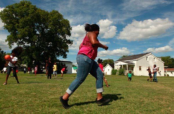 Cadesha Boone, 17, says she isn't worried about her health, but has cut back on drinking soda. She spends her afternoons playing on a grassy field at the Peace of Mind Ministry day camp.